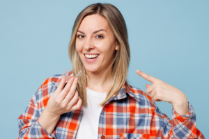 an adult patient holding their Invisalign aligner